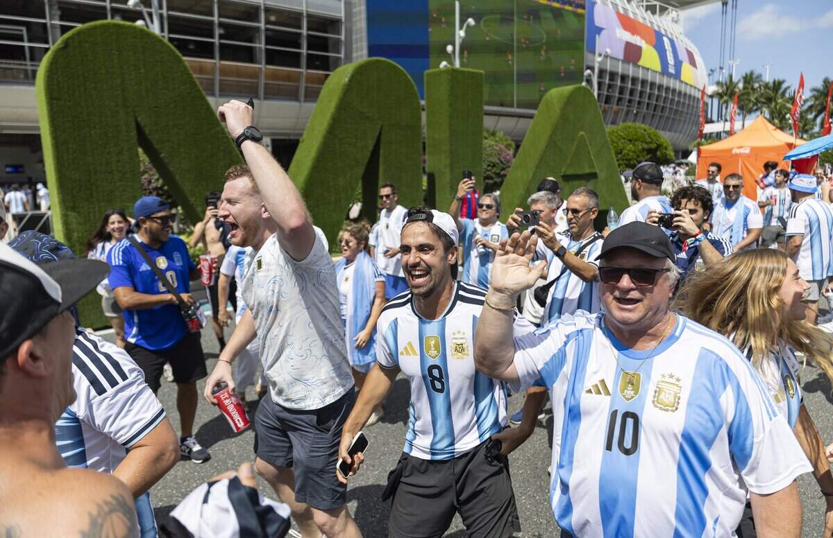 Argentina fan Mariano Jalif, center, dances and sings as he arrives to the Hard Rock Stadium (Miami Stadium) for the FIFA World Cup 2026 Round of 32 soccer match against Cape Verde on Friday, July 3, 2026, in Miami Gardens, Fla.