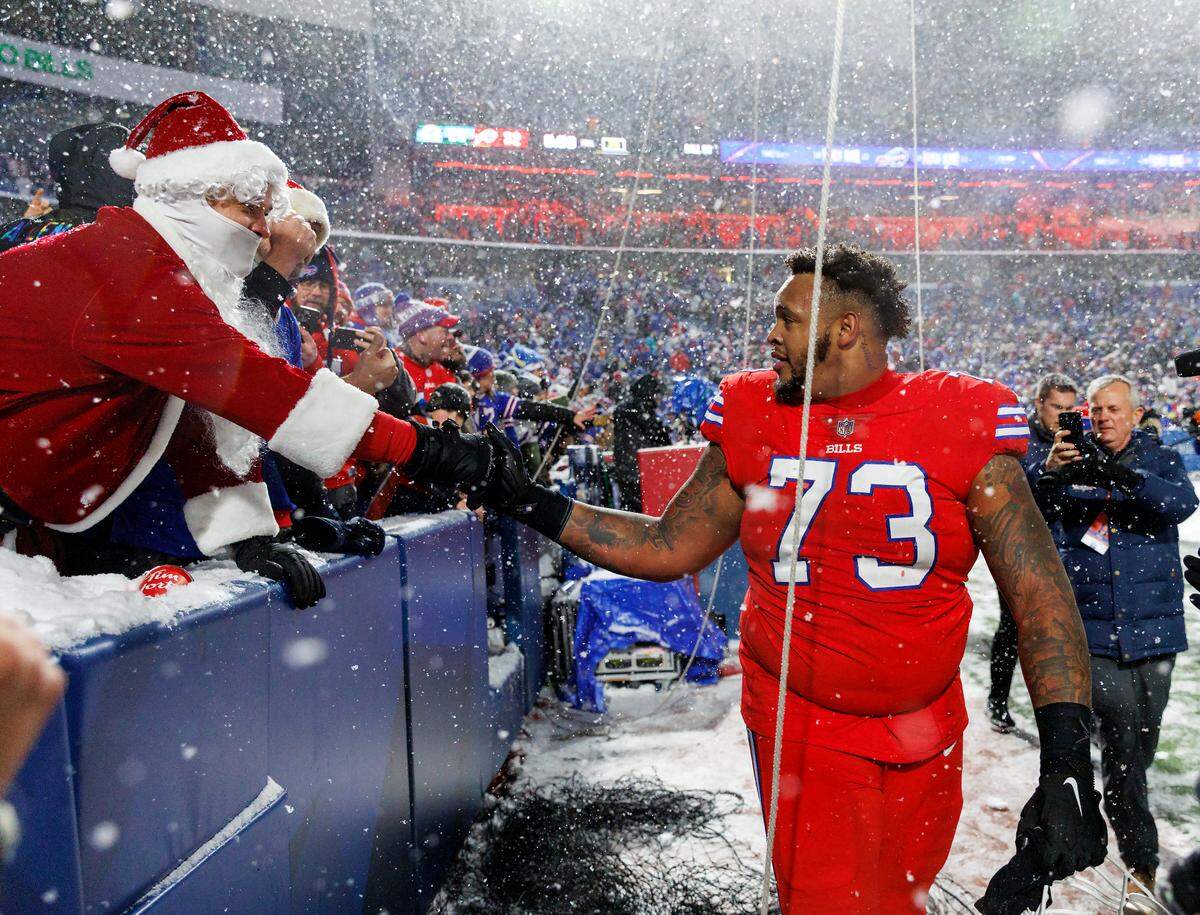 Buffalo Bills offensive tackle Dion Dawkins (73) greets fans after their 32-29 win over the Miami Dolphins during an NFL football game at Highmark Stadium on Saturday, December 17, 2022 in Orchard Park, New York.