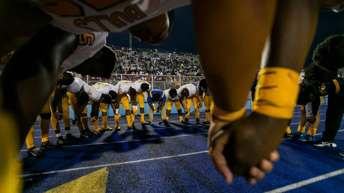 Northwestern Bulls pray before the start of their football game against the Miami Central Rockets on Friday, October 1, 2021 at Nathaniel Traz Powell Stadium in Miami, Florida. The issue in Cambridge Christian’s legal fight isn’t players praying together on the field, it’s having access to the stadium’s public-address system to broadcast a pregame prayer to all in attendance.