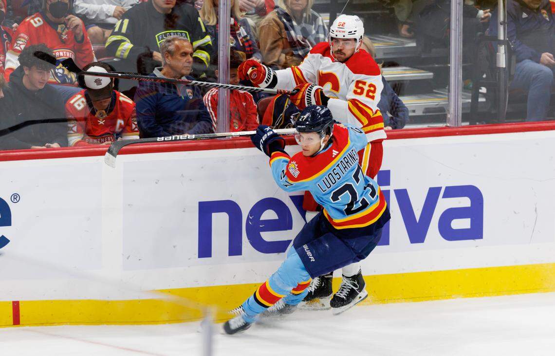 Florida Panthers center Eetu Luostarinen (27) in action against Calgary Flames defenseman MacKenzie Weegar (52) during the first period of an NHL game at FLA Live Arena on Saturday, November 19, 2022 in Sunrise, Fl.