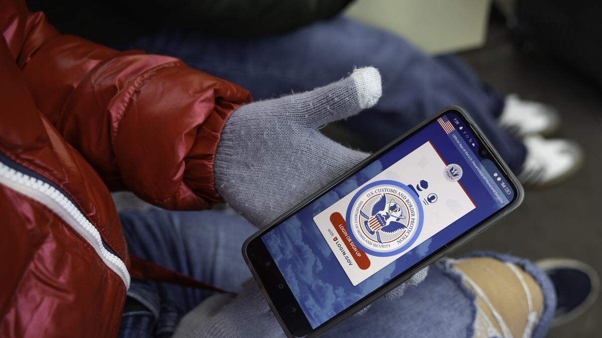 In this file photo, an immigrant from Venezuela tries in vain to access the CBP One app day a day after the second inauguration of U.S. President Donald Trump on January 21, 2025 in Nogales, Mexico. The incoming administration shut down the app, which was created by the Biden administration to allow migrants to schedule appointments to gain entry into the United States.