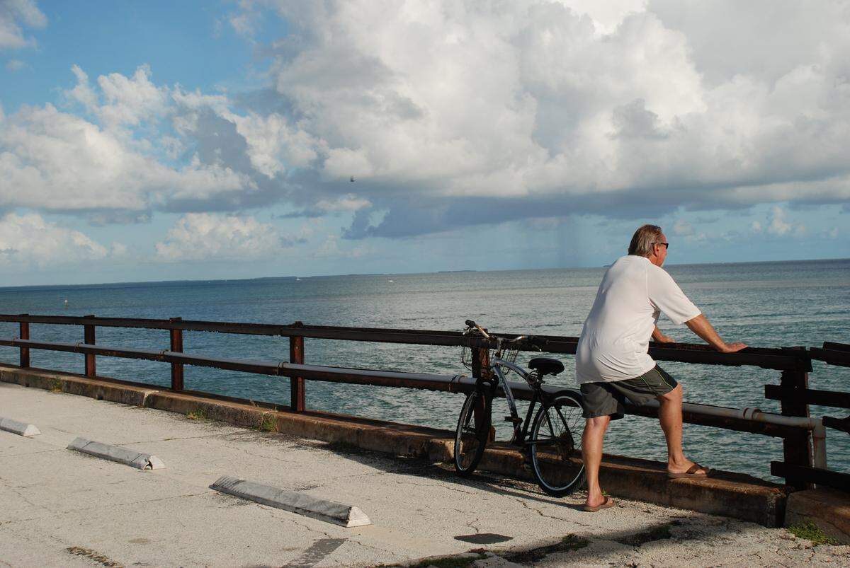 A visitor on the old Seven Mile Bridge watches a storm brewing.
