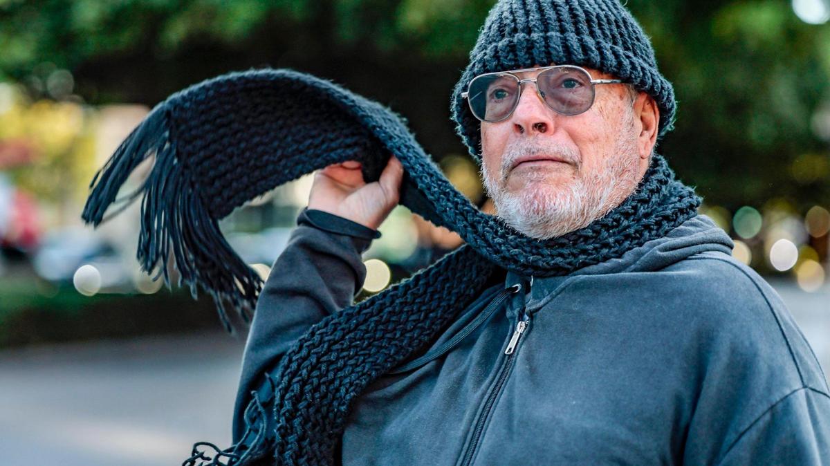 James Martinelli flips his scarf to stay warm while walking along Coral Way as the coldest air of the season arrives in South Florida on Wednesday morning, Jan. 8, 2025.