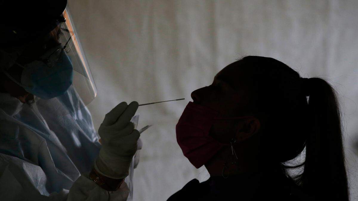 In this stock photo, a health worker collects a nasal swab sample for a COVID-19 test in Mexico City, Wednesday, April 14, 2021.
