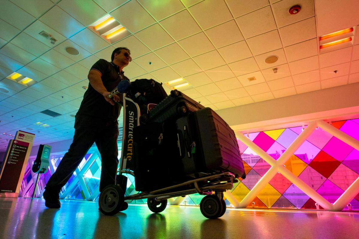 A traveler walks through Miami International Airport in Miami, Florida, on Monday, November 22, 2021.
