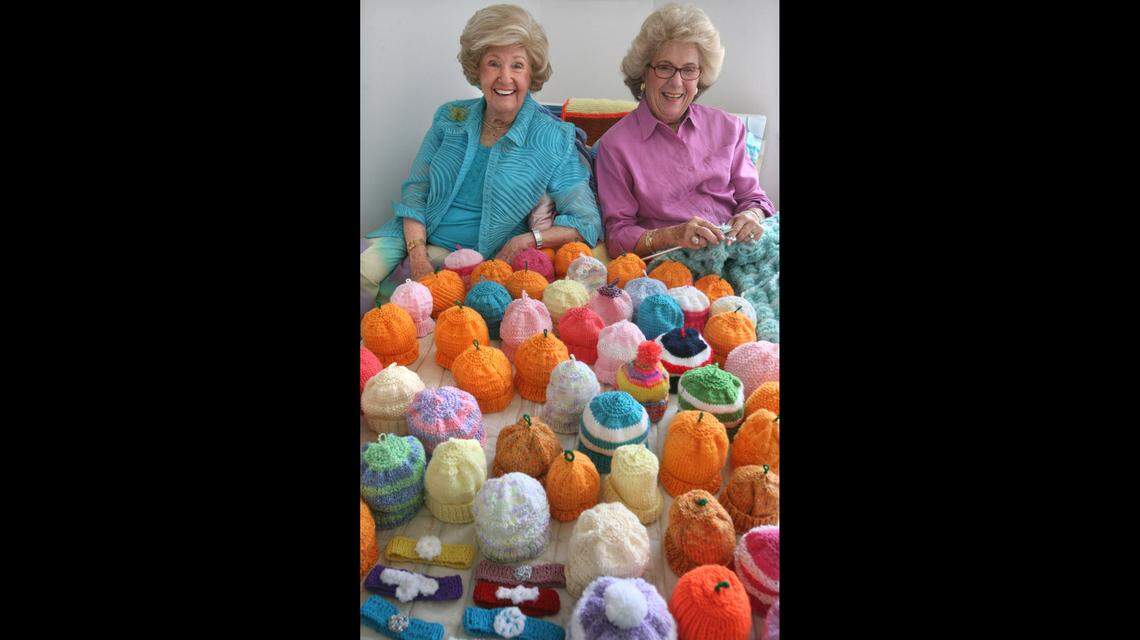 Mazie Ford, 102, of Hallandale Beach, and her daughter Johann Levinson, 80, of Pompano, knit hundreds of caps, blankets and head bands for newborn and sick babies at Joe DiMaggio Children’s Hospital in Hollywood. Here, in this 2008 file photo, they pose with several items on display in the guest room where Ford enjoys watching television while she knits nearly every night.
