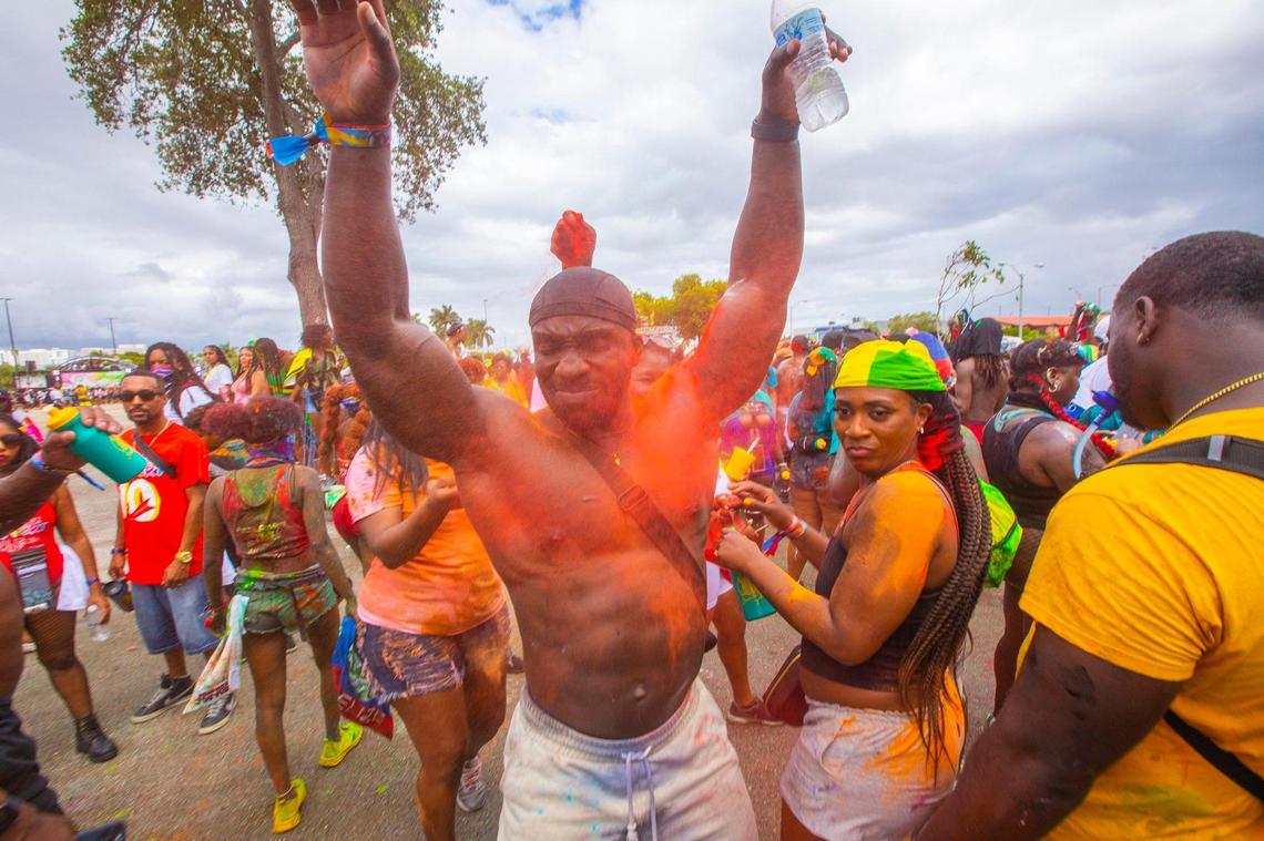Attendees at J’ouvert during Miami Carnival in 2022 get covered in colored powder as they follow bands around.