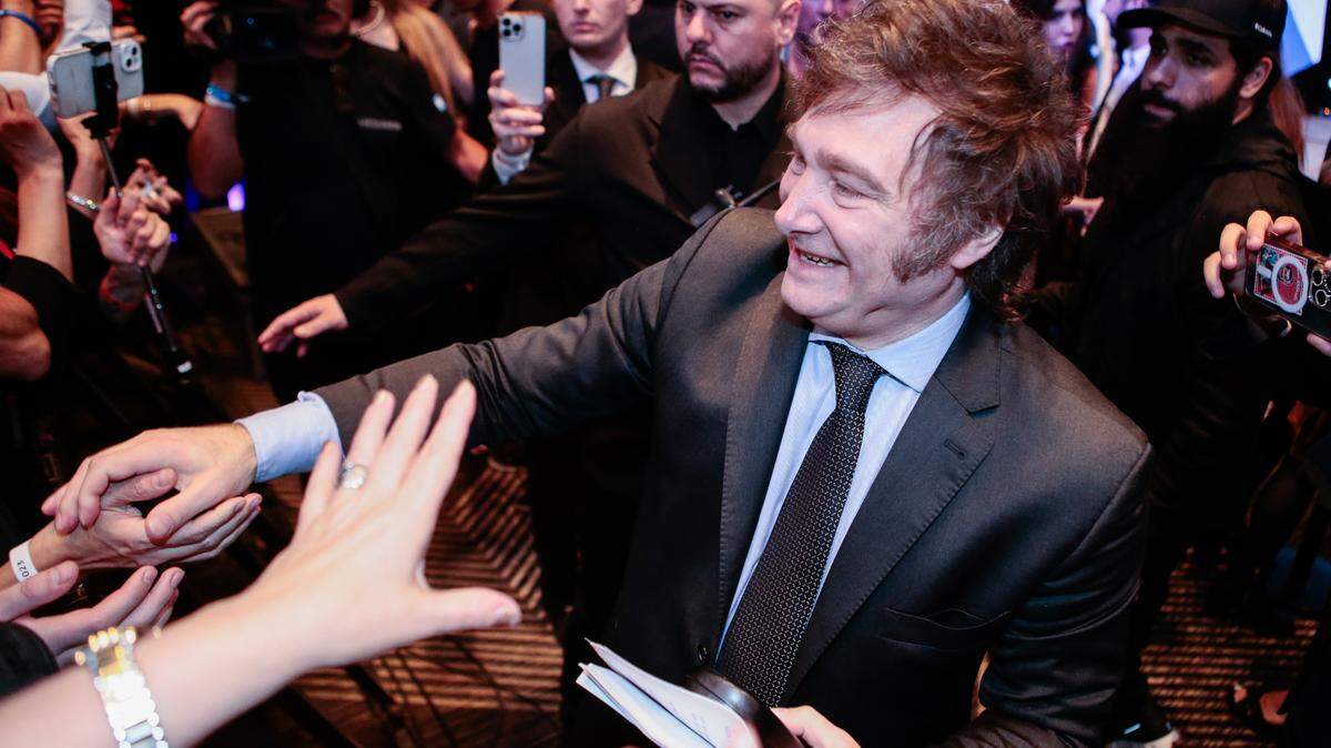 Javier Milei, now president-elect of Argentina, shakes hands with supporters in Buenos Aires on Nov. 19.