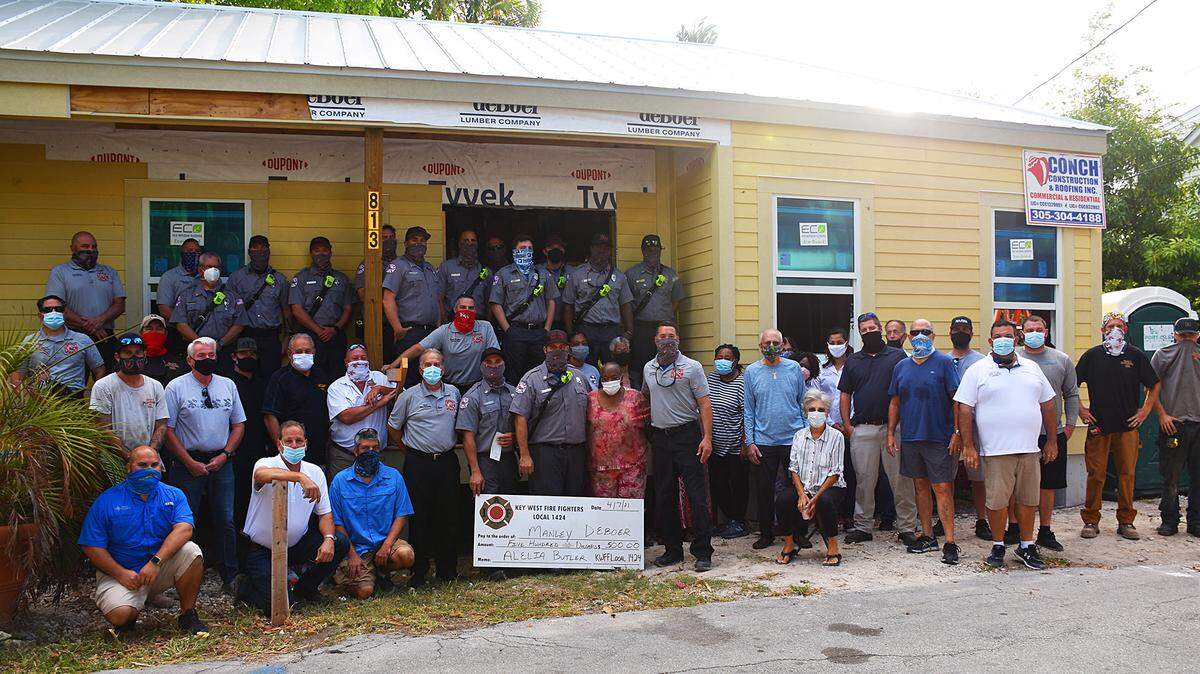 Alelia Butler is surrounded by people in Key West who are building her a home on the property where her mobile home burned down in 2019.