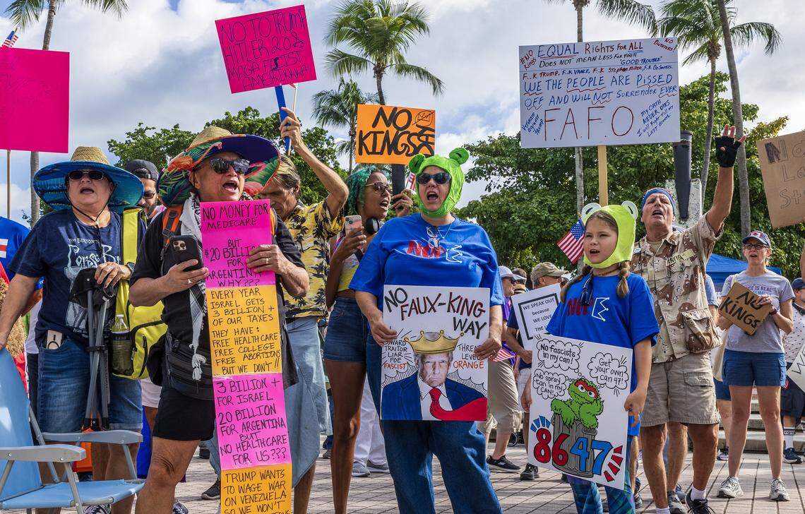 Protesters with homemade signs at ‘No Kings’ anti-Trump protests in downtown Miami. 