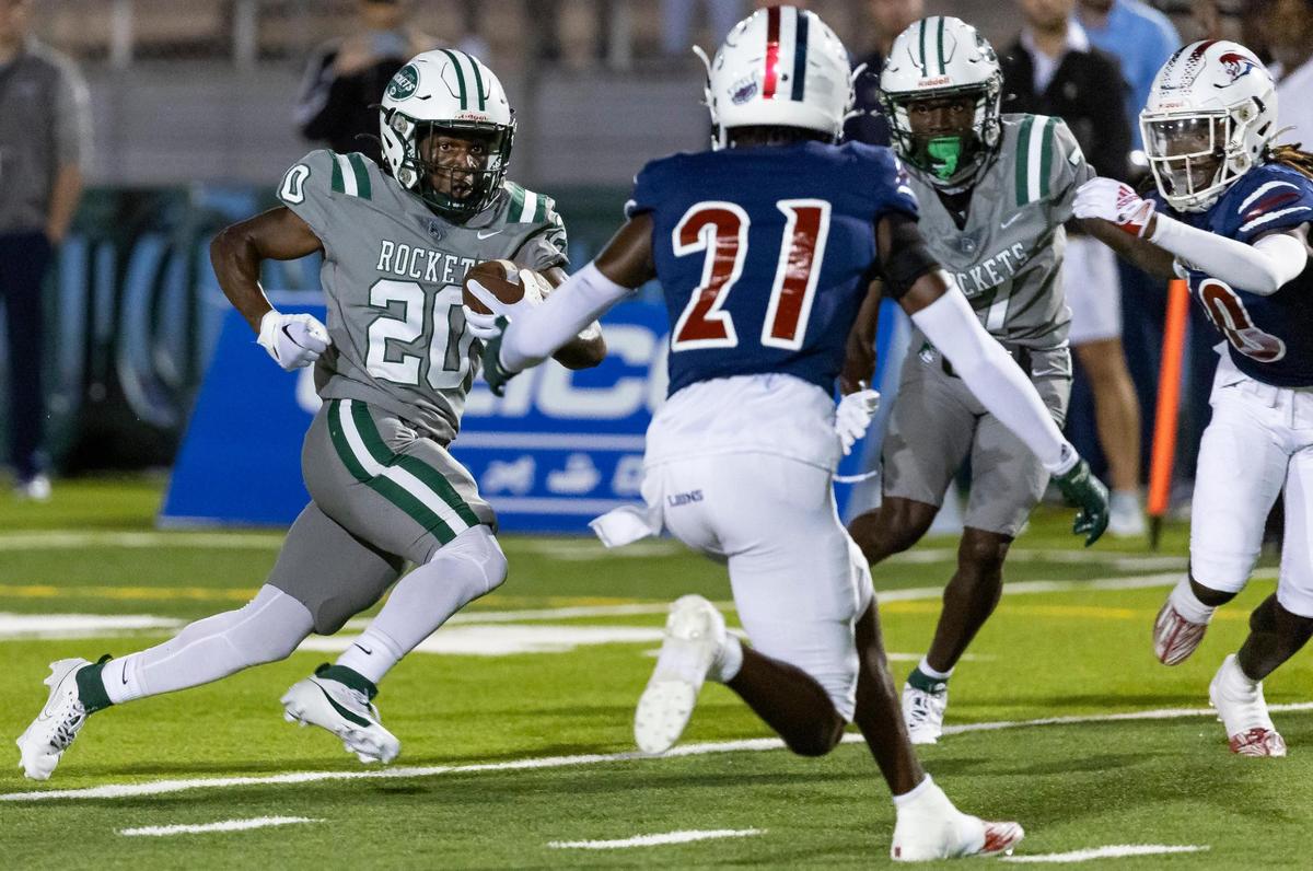 Central Rockets running back Jayden Ford (20) runs with the ball as Chaminade-Madonna Lions defensive back Curtis Janvier (21) tries to tackle in the first quarter of their high school football game at the Nathaniel Traz Powell Stadium on Thursday, Sept. 21, 2023, in Miami, Fla.