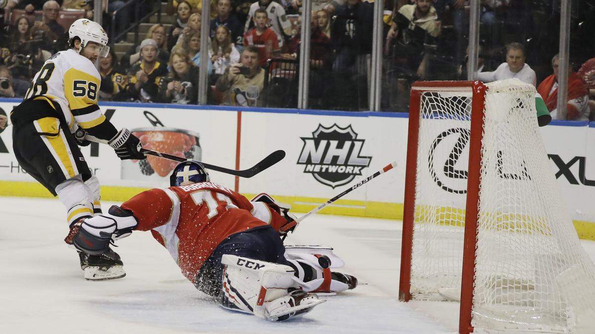 Pittsburgh Penguins defenseman Kris Letang (58) scores against Florida Panthers goaltender Sergei Bobrovsky (72) during the first period of an NHL hockey game against the, Saturday, Feb. 8, 2020, in Sunrise, Fla. (AP Photo/Brynn Anderson)