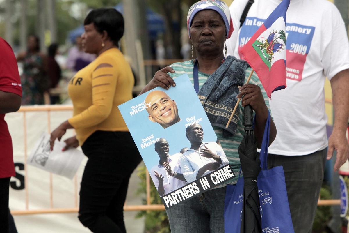 Long-time South Florida resident Lorpina Brave protests the appearance of Michel Martelly during Haitian Flag Day Celebration at the Little Haiti Cultural Center Complex on Friday.