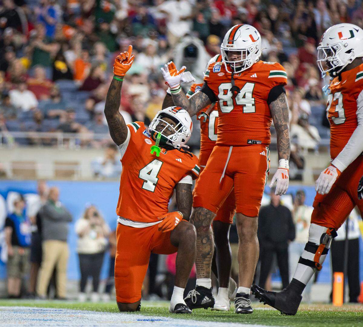 Miami Hurricanes running back Mark Fletcher Jr. (4) celebrates with his teammates after scoring a touchdown against the Iowa State Cyclones in the second half of their Pop-Tarts Bowl football game at the Camping World Stadium on Saturday, Dec. 28, 2024, in Orlando, Fla.