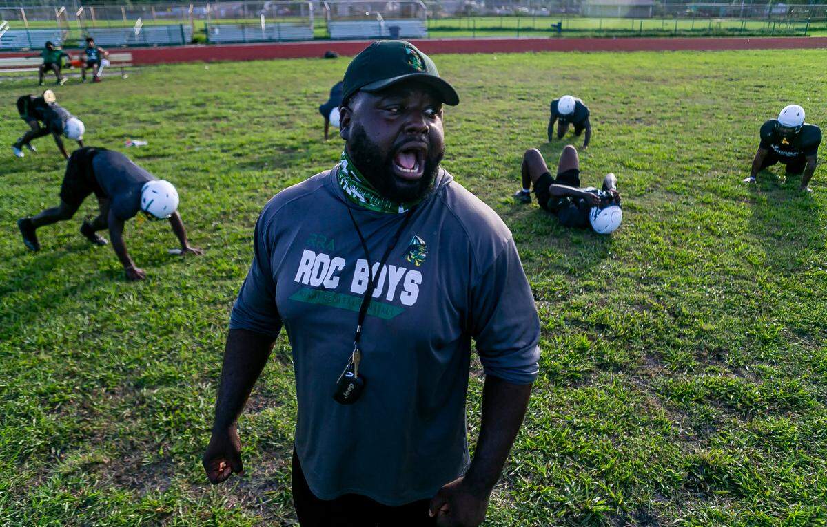 Miami Central assistant coach Jube Joseph leads a training drill during a football preseason practice at the school’s field in Miami’s West Little River neighborhood on Thursday, August 5, 2021.
