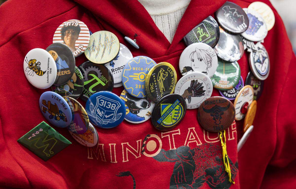 Middleton High School student Roshan Maha Balaji, 16, a member of Minotaur, wears various pins as he participates in the 2026 FIRST Robotics South Florida Regional Competition at the University of Miami’s Watsco Center on Friday, April 10, 2026, in Coral Gables, Fla. Participants from local school districts, surrounding states, and international teams are competing for an opportunity to earn a spot at the 2026 FIRST World Championship.