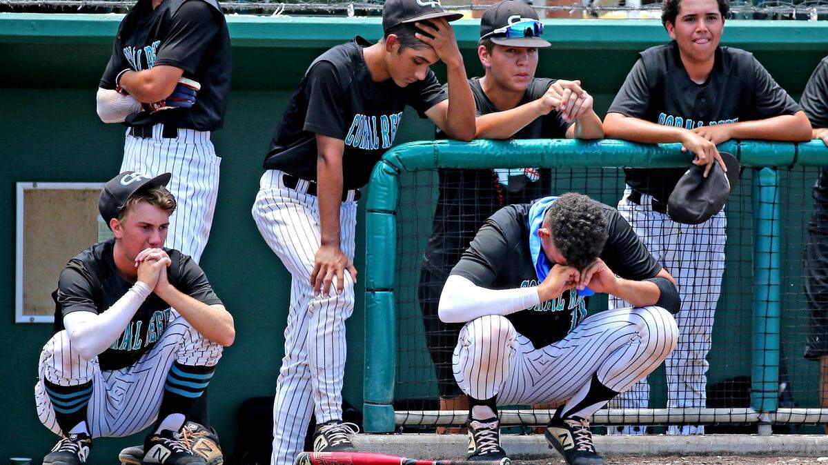 Coral Reef HS players are dejected after they are defeated by Seminole HS 1-0 in the FHSSA Finals Class 9A Division at CenturyLink Sports Complex - Hammond Stadium in Fort Myers, Florida, Saturday, June, 1, 2019.