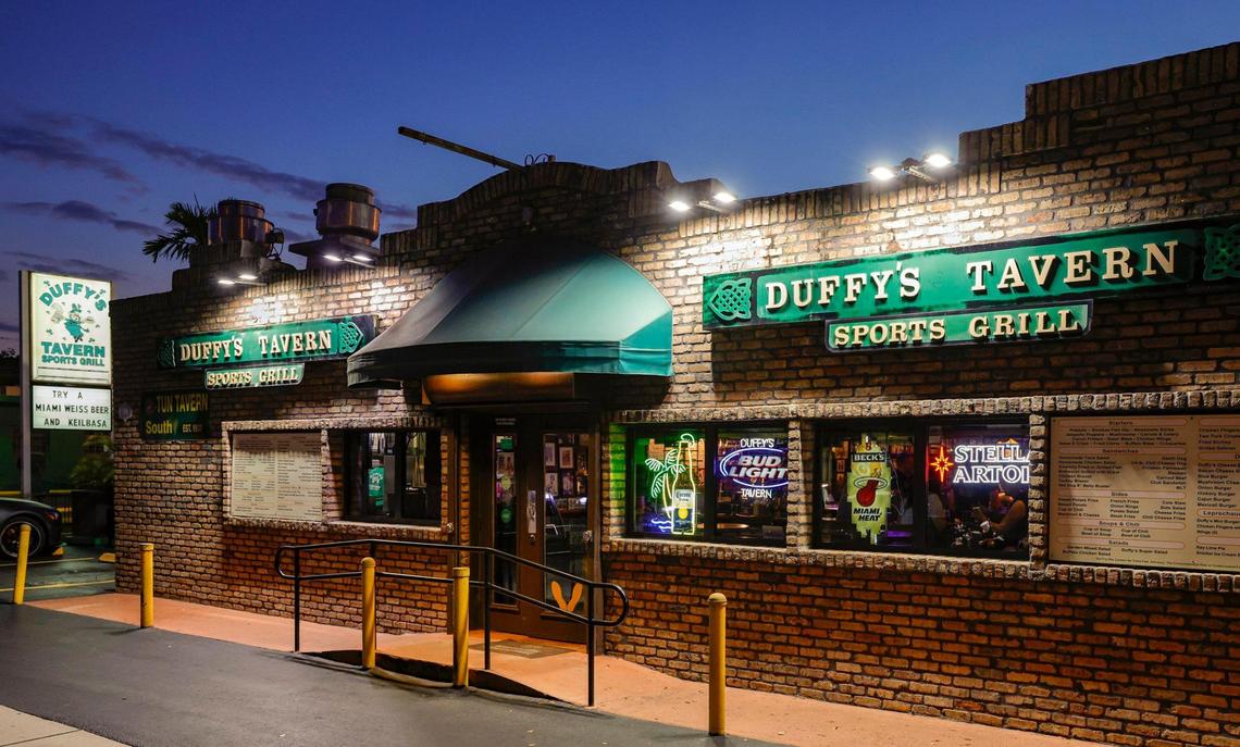 The exterior of Duffy’s Tavern in Miami at sunset. The property is up for sale.