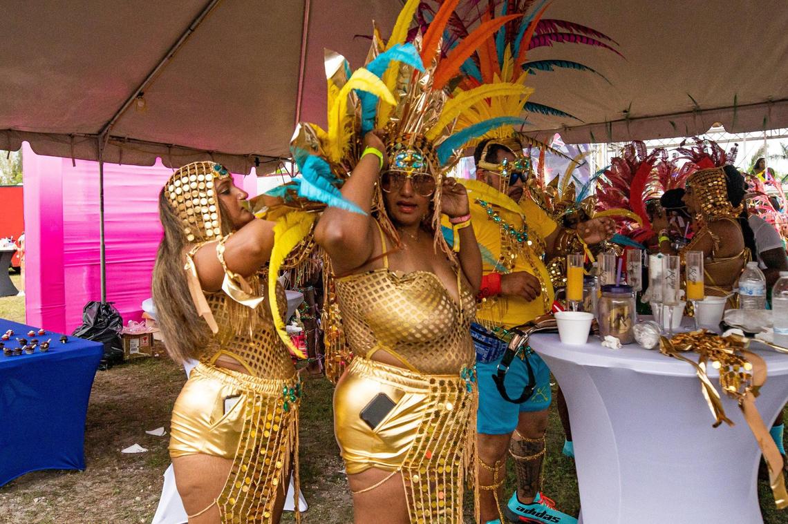 Performers help each other get ready during Miami Carnival at the Miami-Dade County Fair Expo in Miami, Florida on Sunday, October 9, 2022.