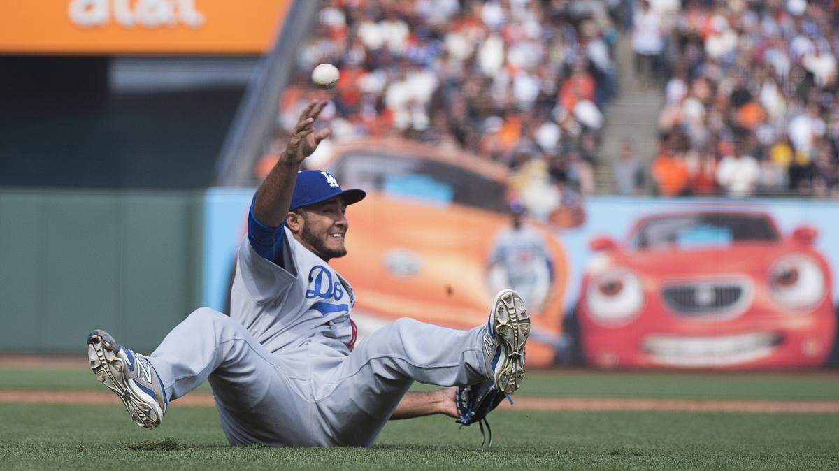 Los Angeles Dodgers relief pitcher Yimi Garcia (63) throws out San Francisco Giants second baseman Ehire Adrianza (13) on a bunt in the sixth inning during the home opening game at AT&T Park on Thursday April 7, 2016 in San Francisco, Calif.