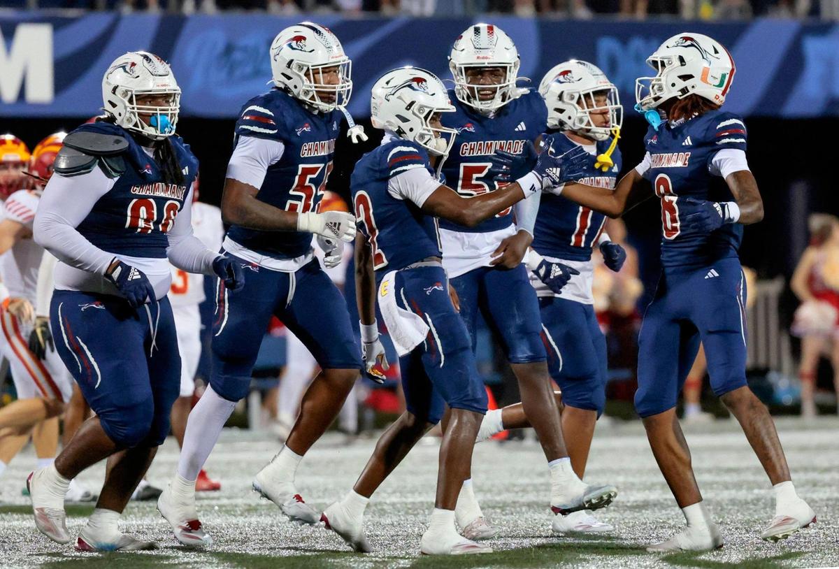 Chaminade-Madonna’s Kelly Sejour Jr. (12) and Chris Ewald (8) and teammates celebrate Sejour’s interception against Clearwater Central Catholic in the first half during the Florida High School Football State Championships - Class 1A game at Pitbull Stadium on the campus of Florida International University in Miami, Florida, on Wednesday, December 11, 2024.