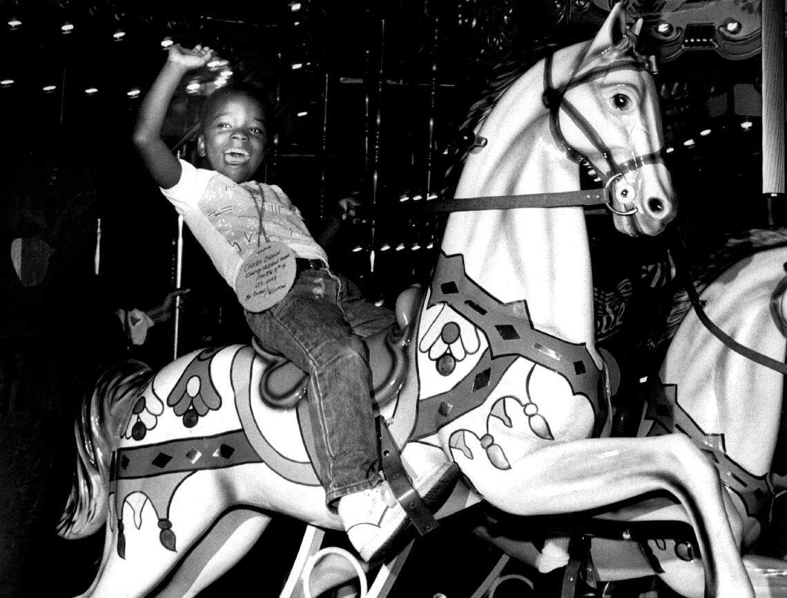 Kids ride the carrousel at the Omni.