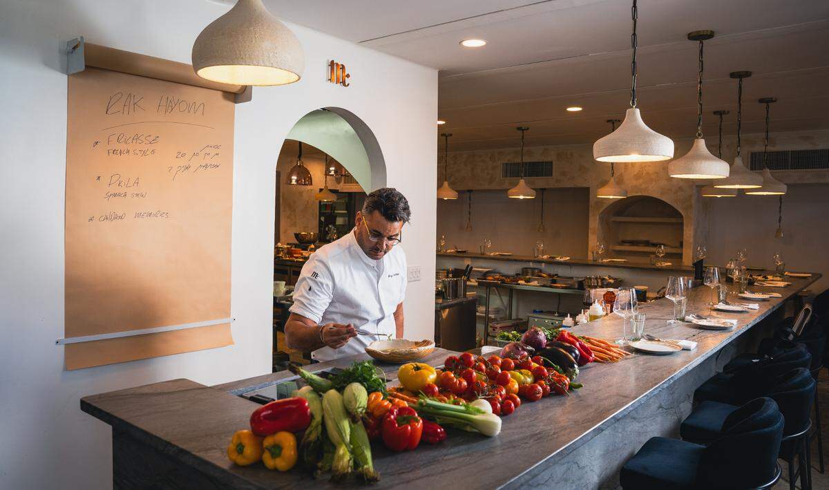 Chef and owner Raz Shabtai at the counter at Mutra, his kosher Israeli restaurant.