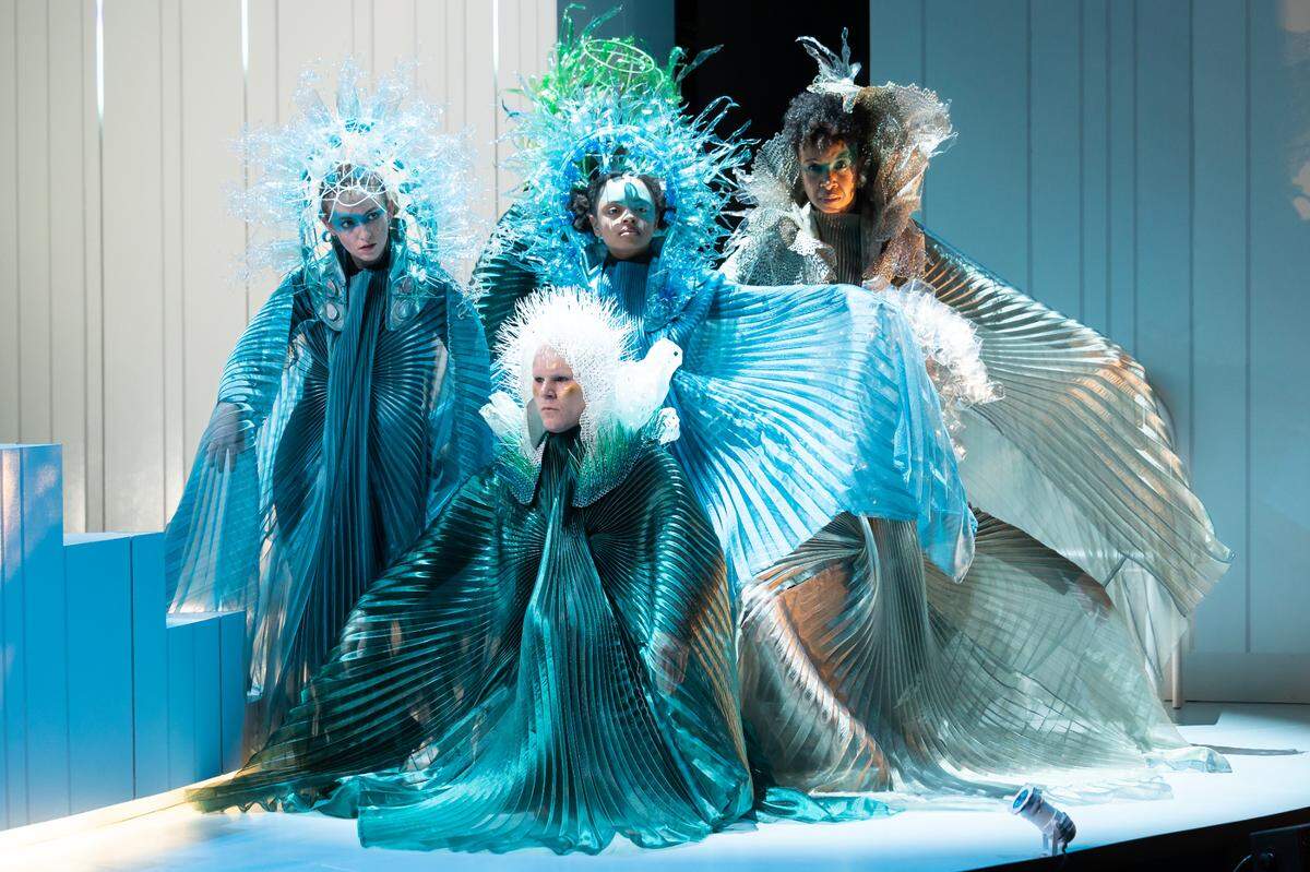 The Ocean Choir enters in costumes and headdresses designed by award-winning Serbian costumer Olivera Gajic in “Ocean Filibuster” in a photo from the American Repertory Theater Production. The headpieces are fashioned from heated and stretched plastic water bottles. (Photo courtesy of Maggie Hall)