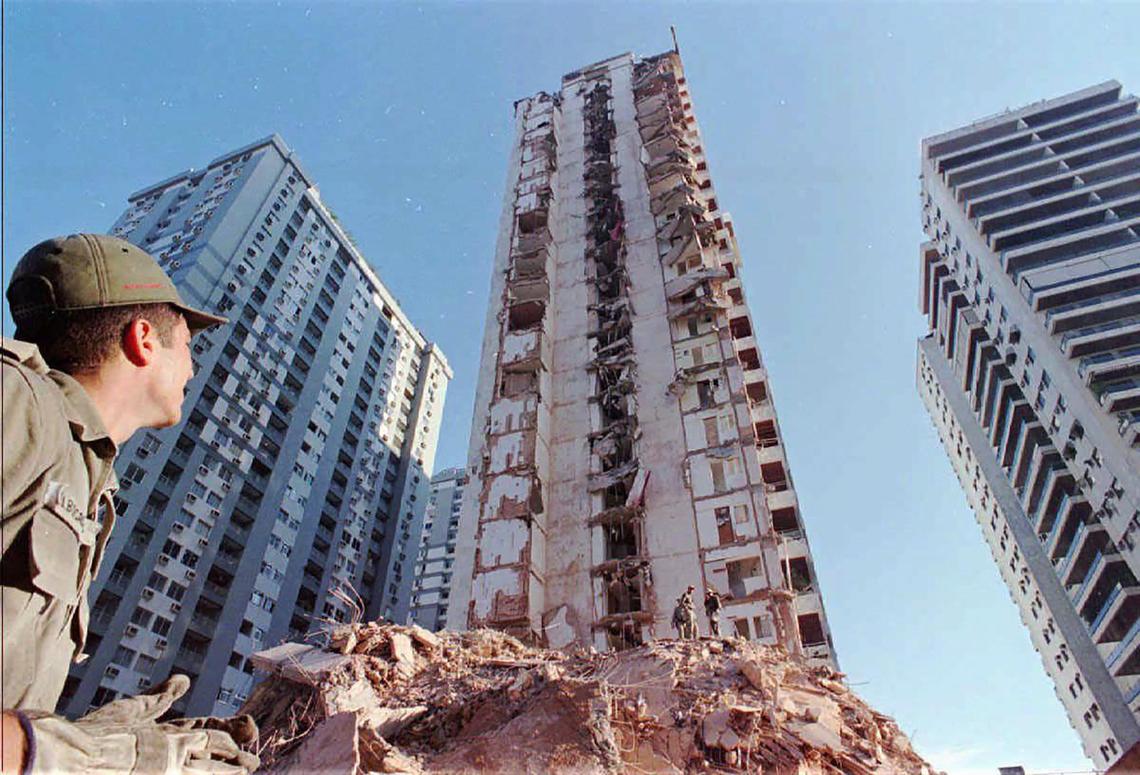 A firefighter from Rio De Janeiro, Brazil, looks at the partially collapsed 22-story Palace II before what was left of it was imploded. The apartment tower collapsed Feb. 22, 1988, killing eight people and leaving 120 families homeless.