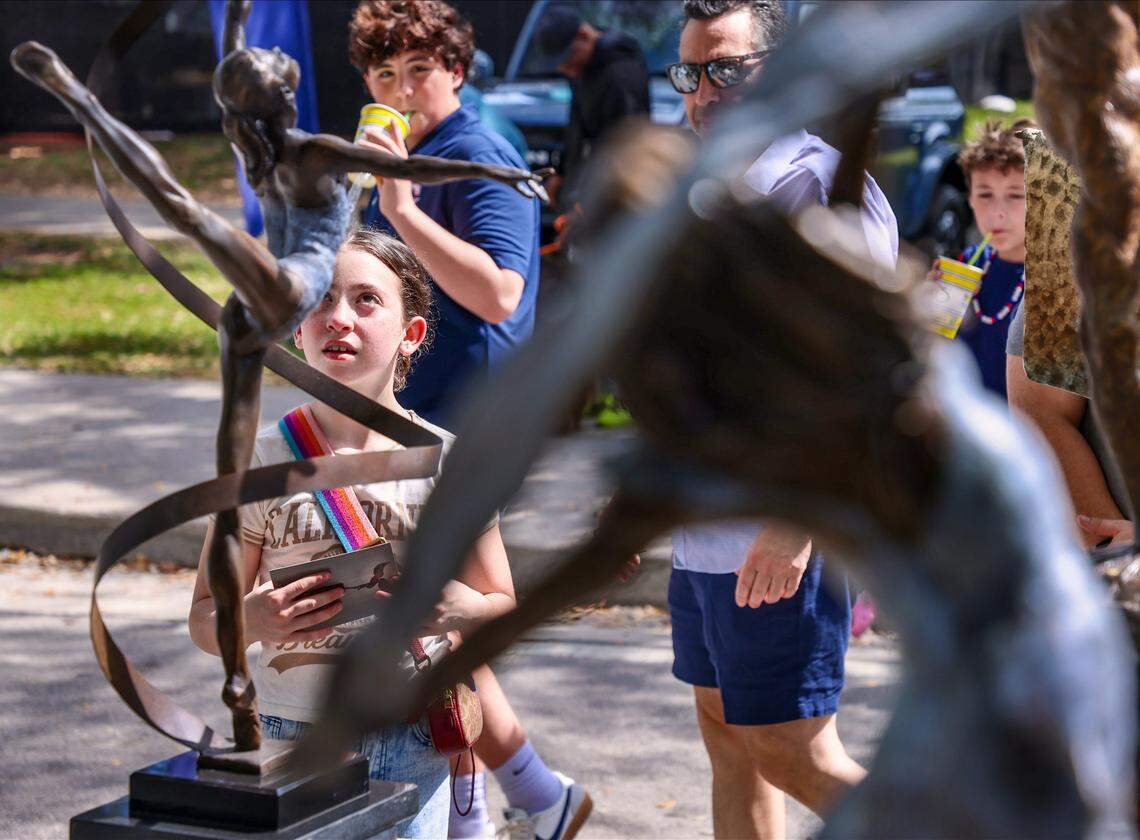 Young gymnast Emma Ranallo, 10, is transfixed by the Lori Betz's “Ribbon Dancer” at the Coconut Grove Art Festival.