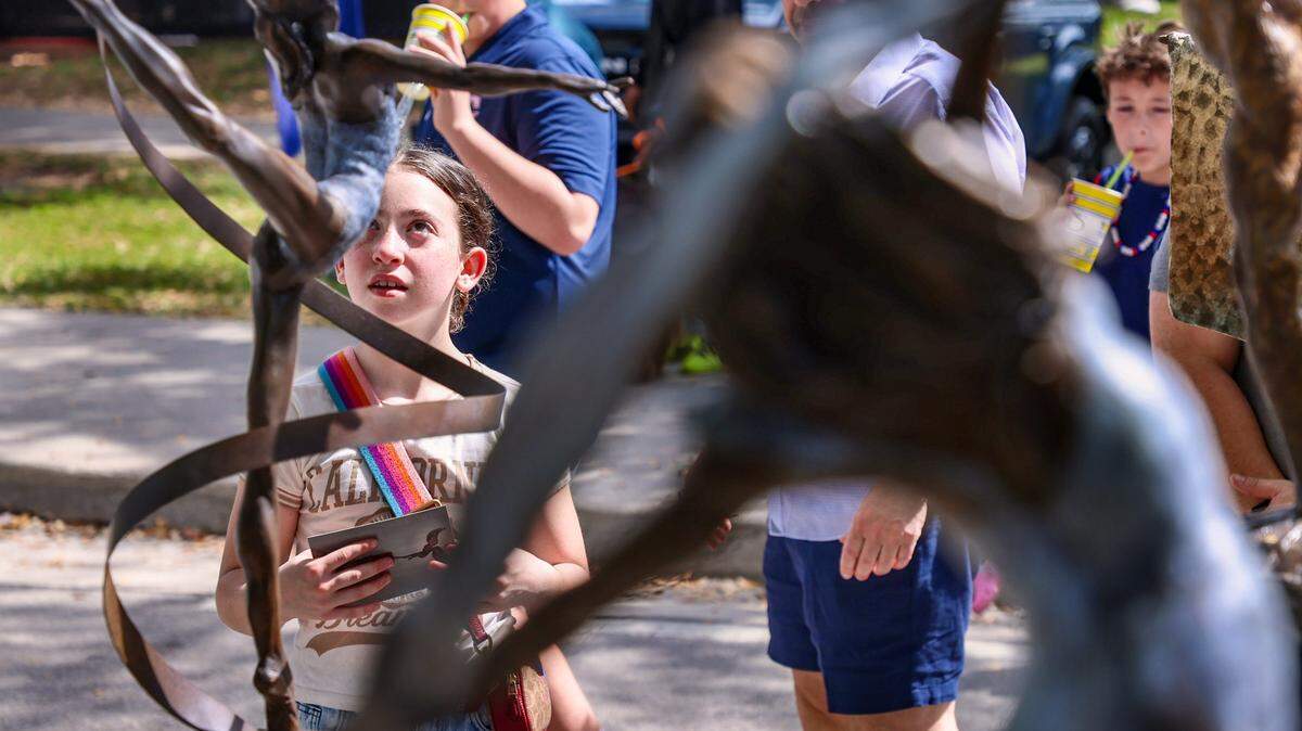 Young gymnast Emma Ranallo, 10, is transfixed by the Lori Betz's “Ribbon Dancer” at the Coconut Grove Art Festival.

The 62nd Coconut Grove Arts Festival returned to the Coconut Grove waterfront over Presidents Day weekend. Centered at Regatta Park in Dinner Key Marina overlooking Biscayne Bay, the festival spanned McFarlane Road, Pan American Drive and South Bayshore Drive, where the works of more than 275 artists were on display on Sunday, February 15, 2026, in Miami, Florida. 