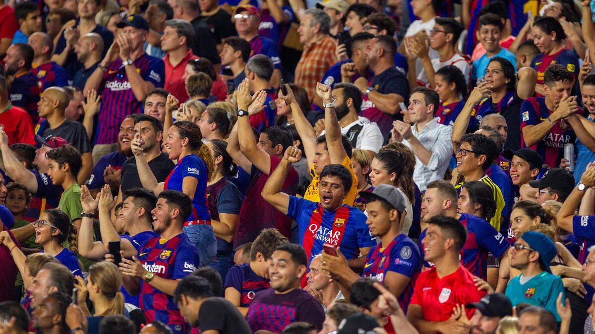 FC Barcelona fans celebrate the team’s second goal during the second half of a La Liga Serie A game against SSC Napoli at Hard Rock Stadium in Miami Gardens, Florida, on Wednesday, August 7, 2019.