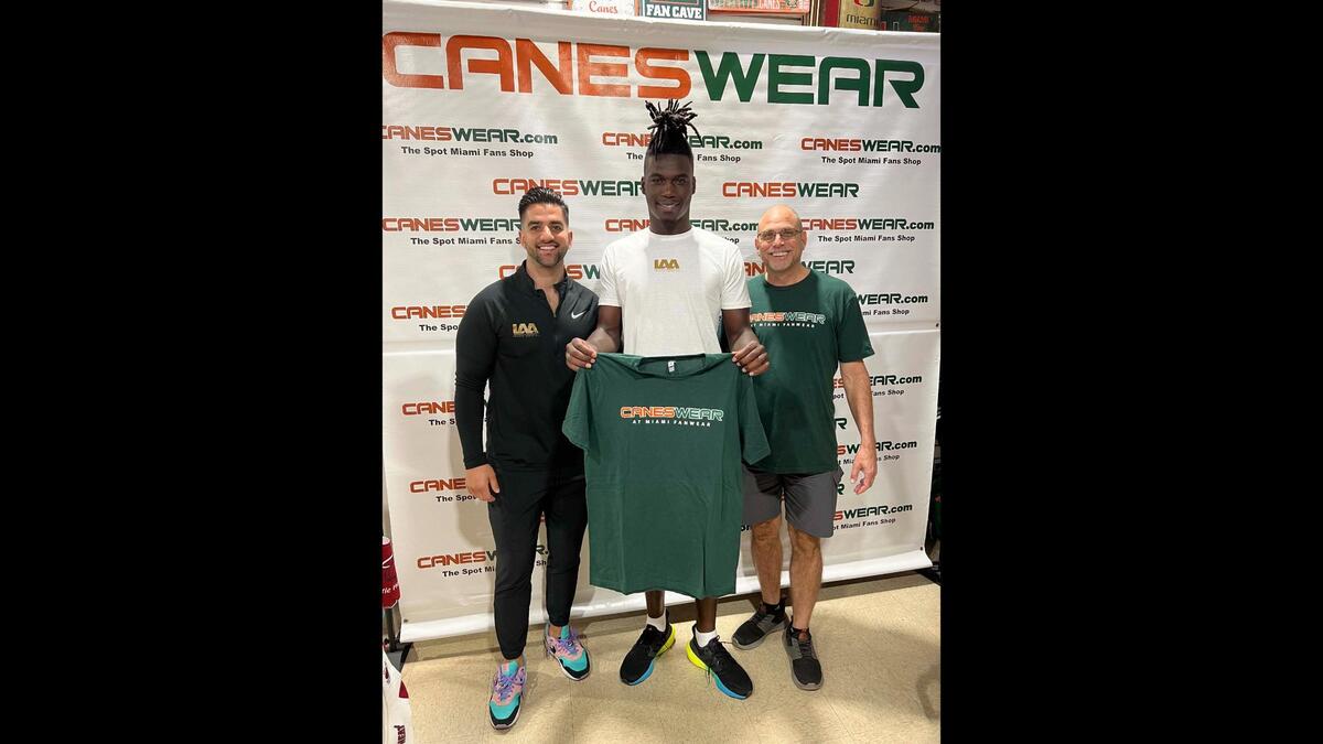 LAA director of marketing Eric Dounn (left) is shown with UM safety James Williams and CanesWear owner Brett Gittelman.