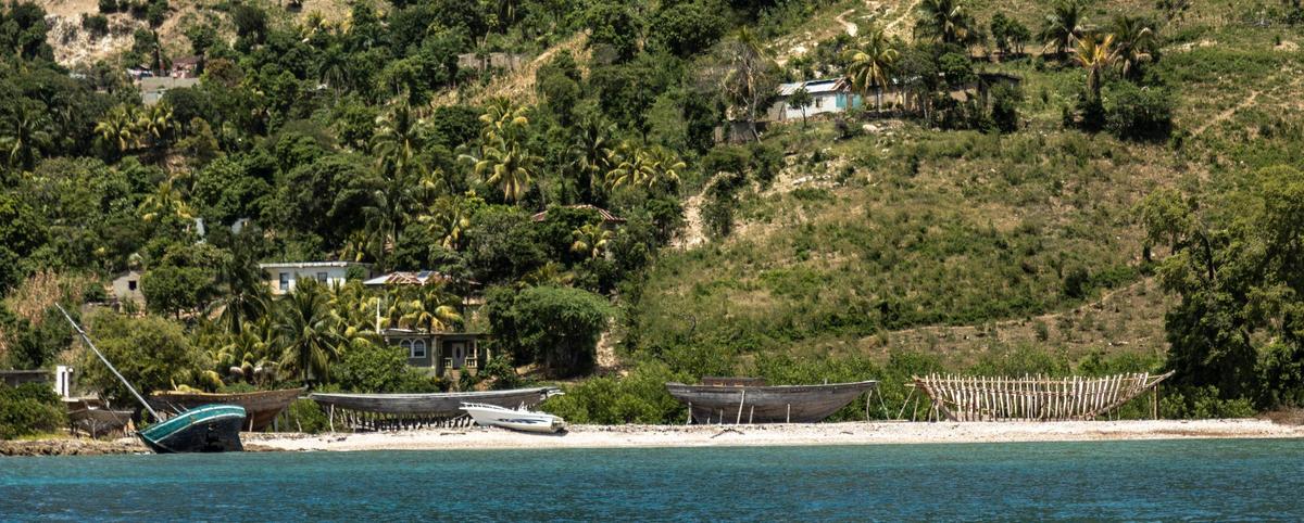 Boats in various stages of construction line a beach on Île de la Tortue, March 26, 2022. The island was at one time or another a notorious base for buccaneers, a port of call for pirates whose fictional exploits there have been a staple of Hollywood movies.