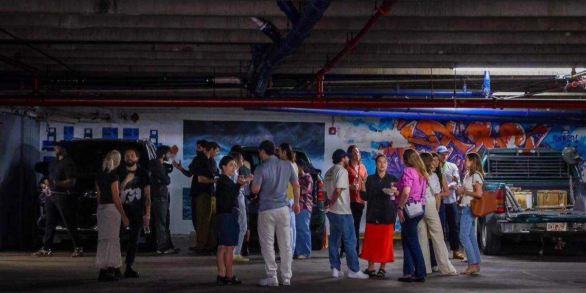 Luna Palazzolo-Daboul, center/left, speaks with Alex Gartenfeld, ICA Miami artistic director, center/right, as museum cohorts gather for a tour of the Tunnel Projects, an art space dedicated to supporting local artists, on Saturday, April 11, 2026, in Little Havana, Miami.