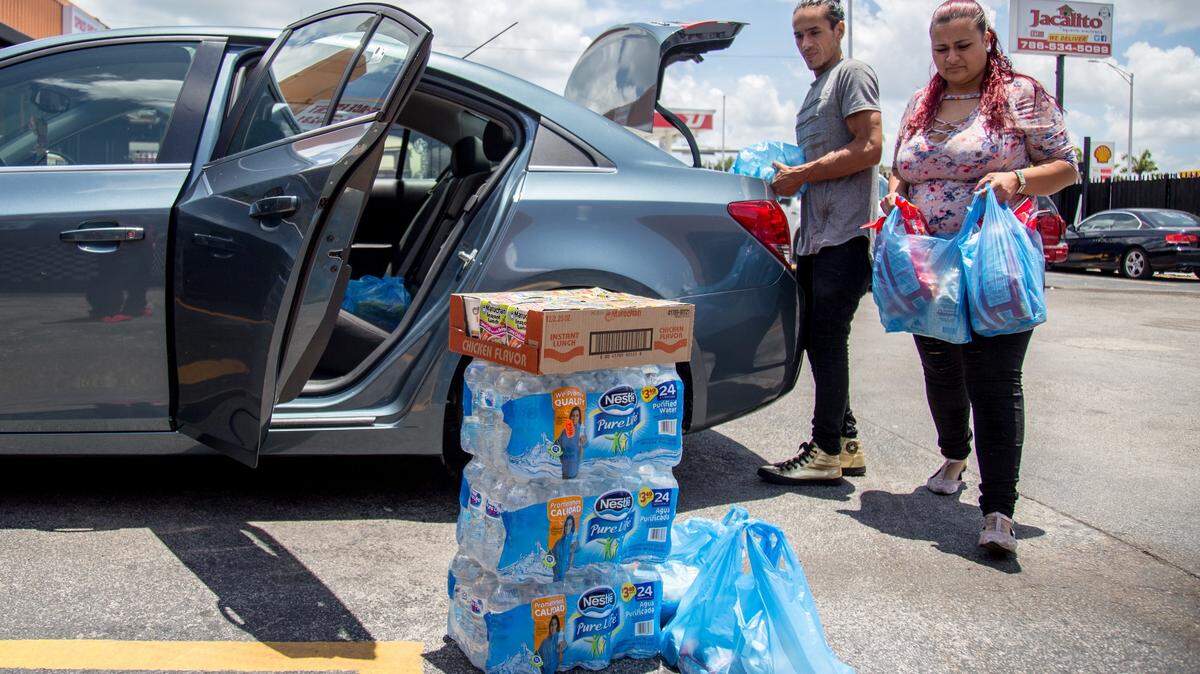 Lucas Varela and Estephani Ruiz arrive at Jacalito Mexican Restaurant on Tuesday, June 8, 2018, in Little Havana with  food and water donations for those affected in Guatemala by the eruption of the volcano called Volcan de Fuego.