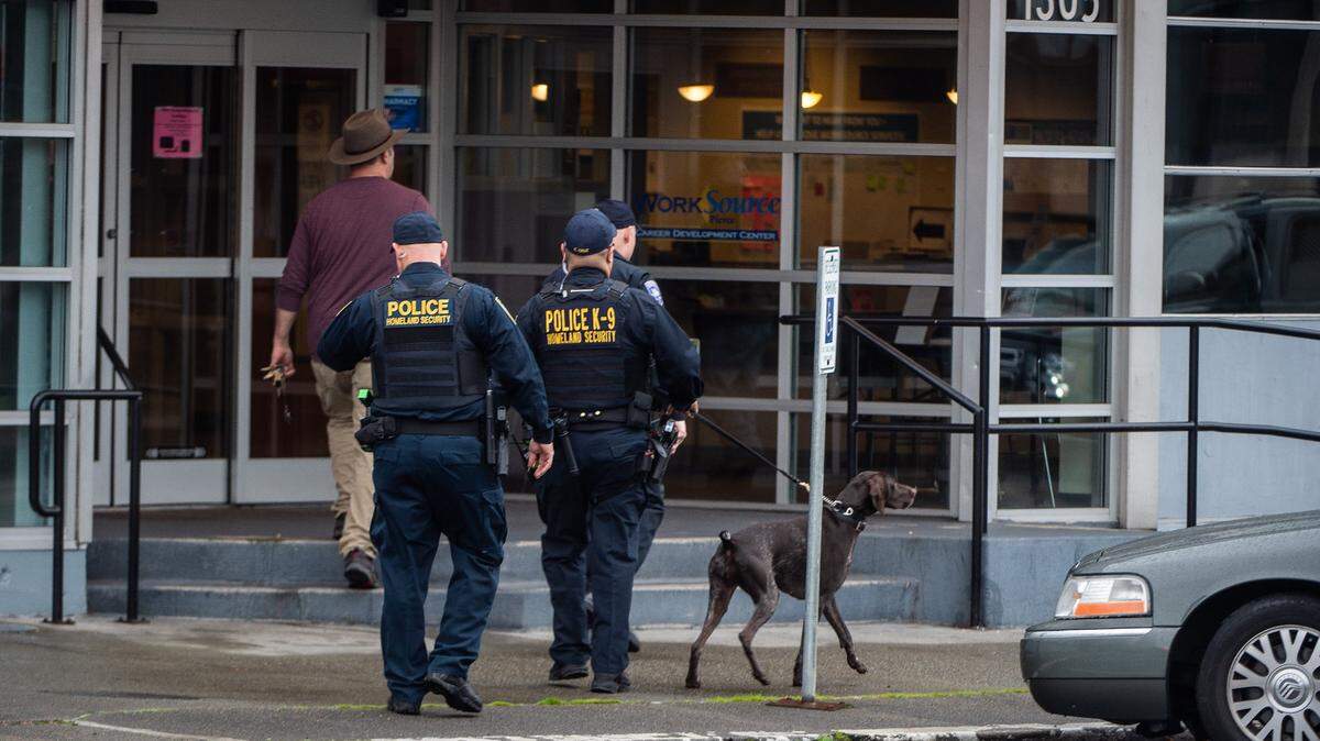 Bomb-sniffing dogs investigate a bomb threat in Tacoma, Washington, on Thursday, Oct. 25, 2018.