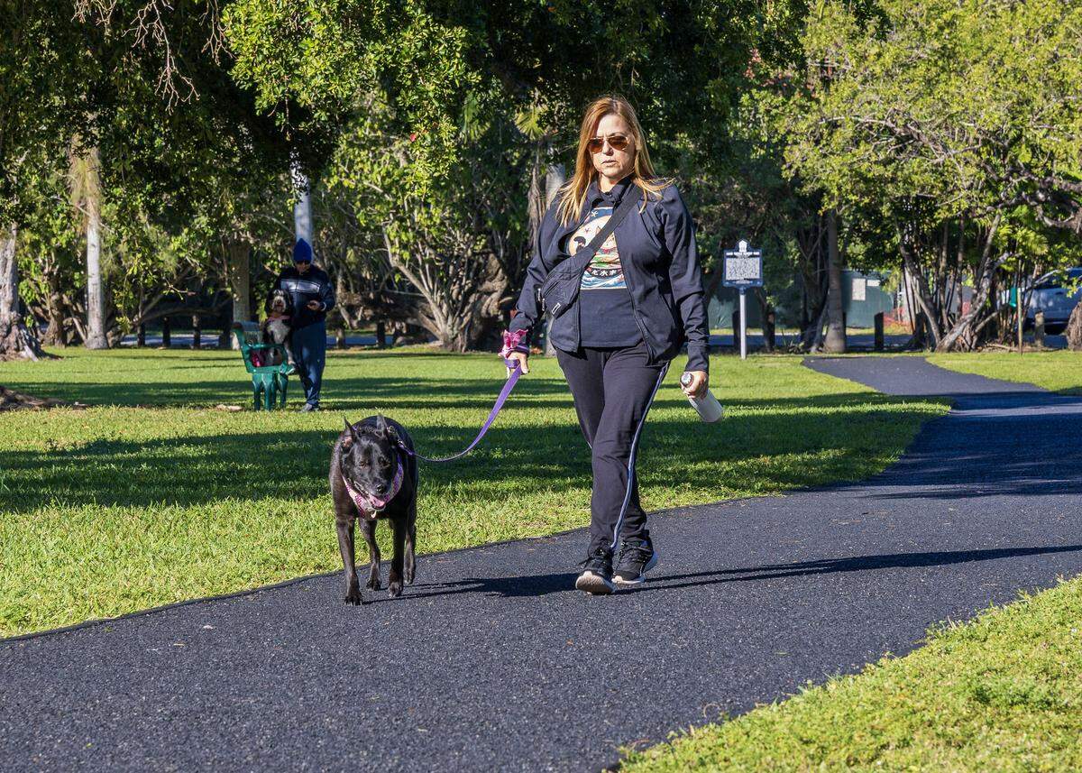 The cold temperatures didn't stop Denise Llerena from taking her dog for a walk at David Kennedy Park in Coconut Grove, as Miami woke to one of its coldest New Year's Eves in decades, on Wednesday, December 31, 2025. 