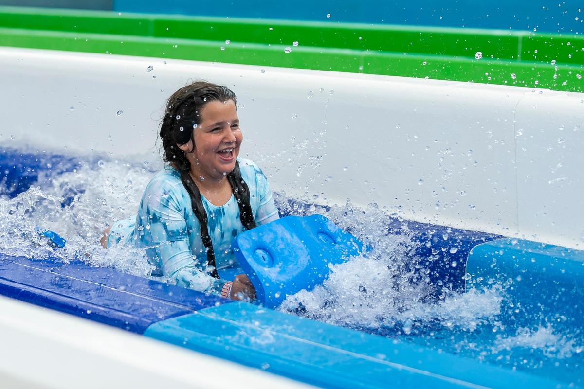 A guest rides down a waterslide at Tidal Cove Waterpark in Aventura’s JW Marriott Miami Turnberry Resort & Spa on Saturday, June 8, 2019. The park has seven water slides, a FlowRider surfing pool and a lazy river among other amenities.