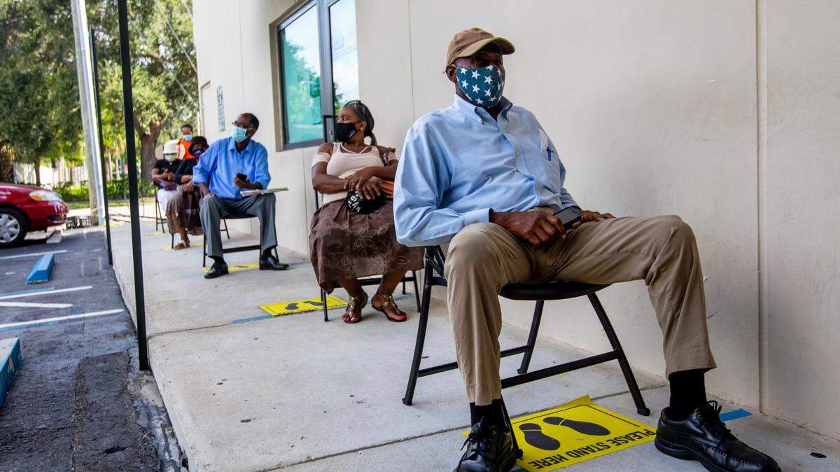 Perejona Lavenal is socially distanced as he awaits his turn for assistance with unemployment at Sant La Haitian Neighborhood Center in North Miami on Aug. 11, 2020. Deloitte Consulting’s work on the state’s unemployment system left millions of Floridians unable to collect unemployment claims. Deloitte now is at the center of a $135 million disputed contract with the state on Medicaid data.