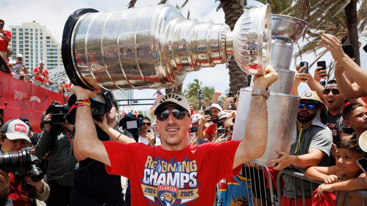 Florida Panthers center Brad Marchand (63) holds the Stanley Cup above his head during the Panthers’ championship celebration on June 22, 2025 in Fort Lauderdale. 