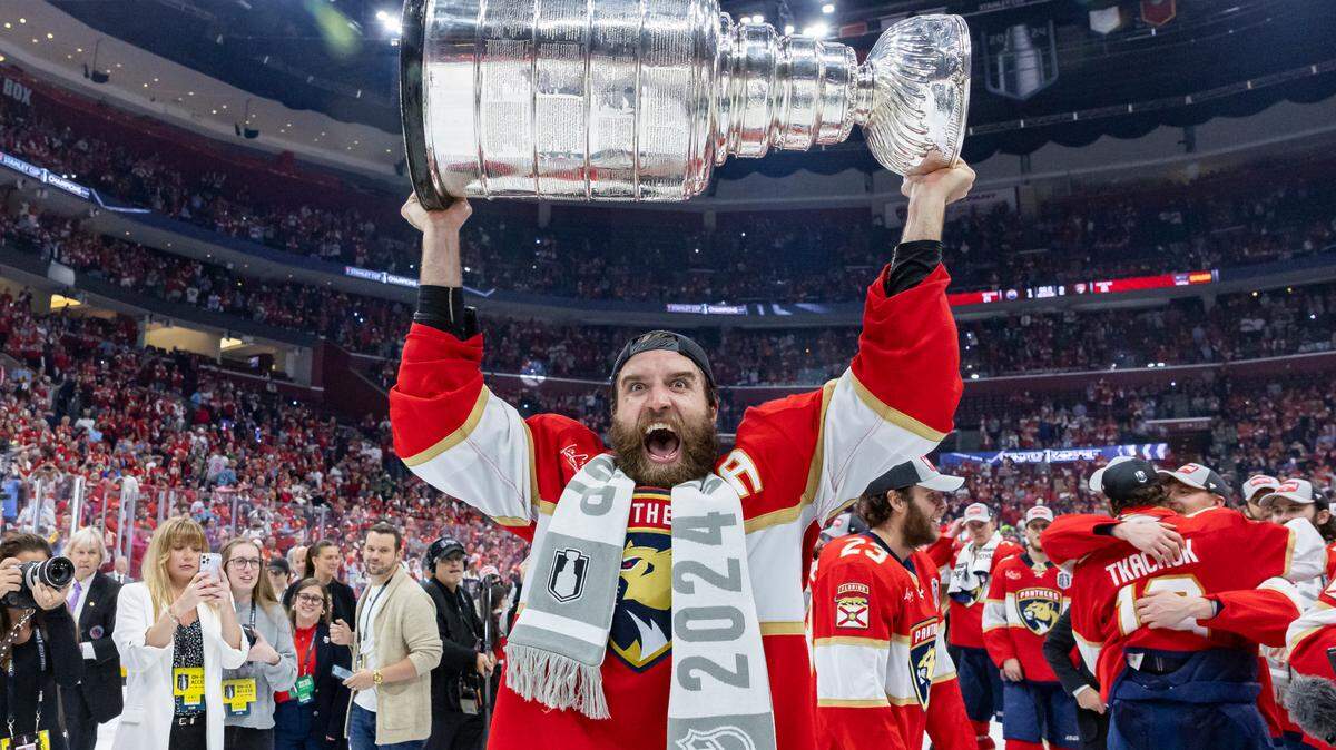 Florida Panthers defenseman Aaron Ekblad (5) lifts the Stanley Cup after defeating the Edmonton Oilers in Game 7 of the Stanley Cup Final at Amerant Bank Arena on Monday, June 24, 2024, in Sunrise, Fla.