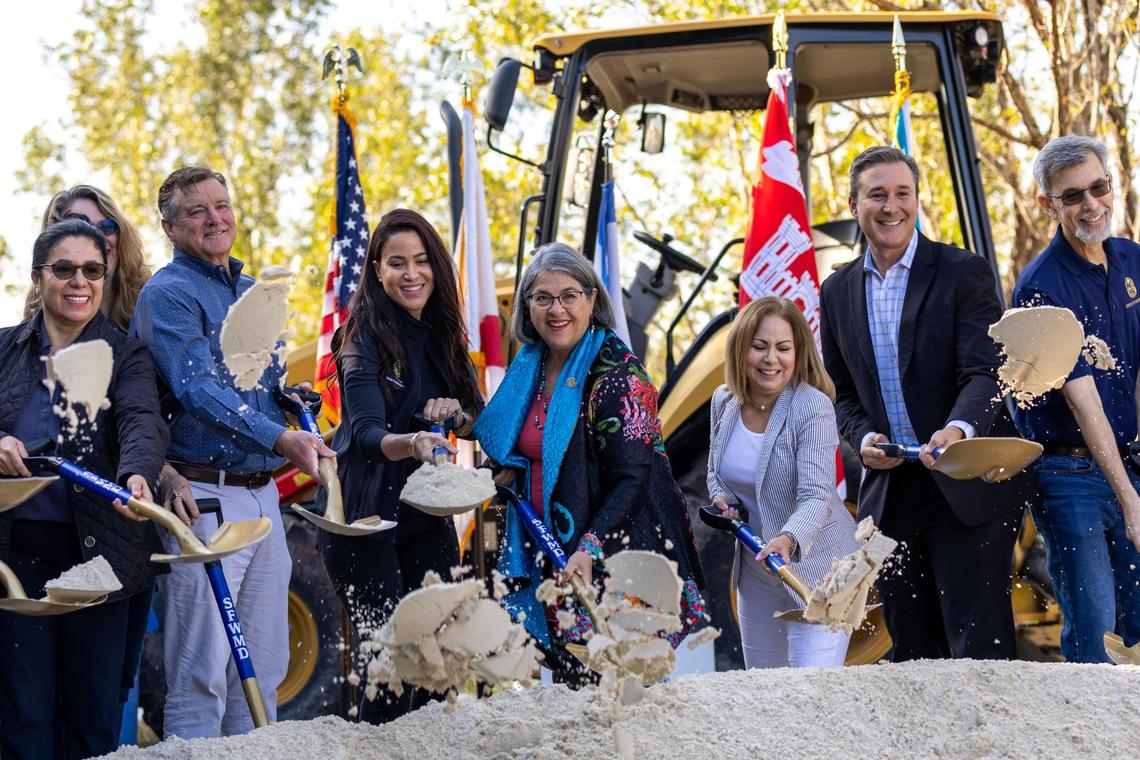 Representatives for Miami-Dade County, the South Florida Water Management District and the U.S. Army Corps of Engineers toss sand during a ‘ground breaking’ on the final component of the Biscayne Bay Coastal Wetlands Project near Black Point Marina in Homestead, Florida, on Tuesday, March 21, 2023.