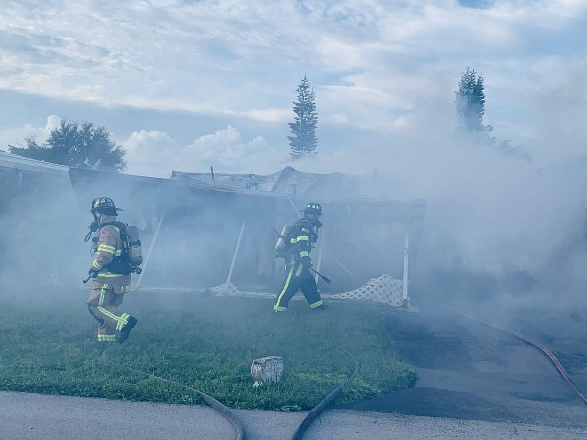 Broward Sheriff Fire Rescue and Hollywood Fire Rescue firefighters work to put out a fire in a mobile home in Dania Beach Sept. 4, 2019.