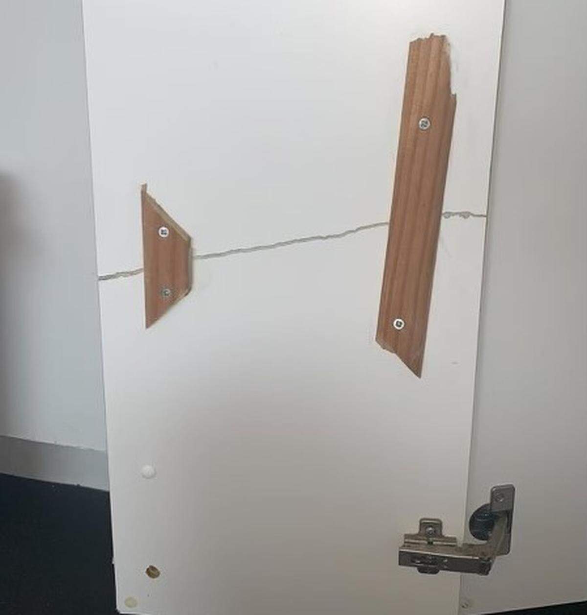 Strips of wood are used to repair a cabinet door inside one of the units of Mariner Place apartments in the Middle Florida Keys city of Marathon.