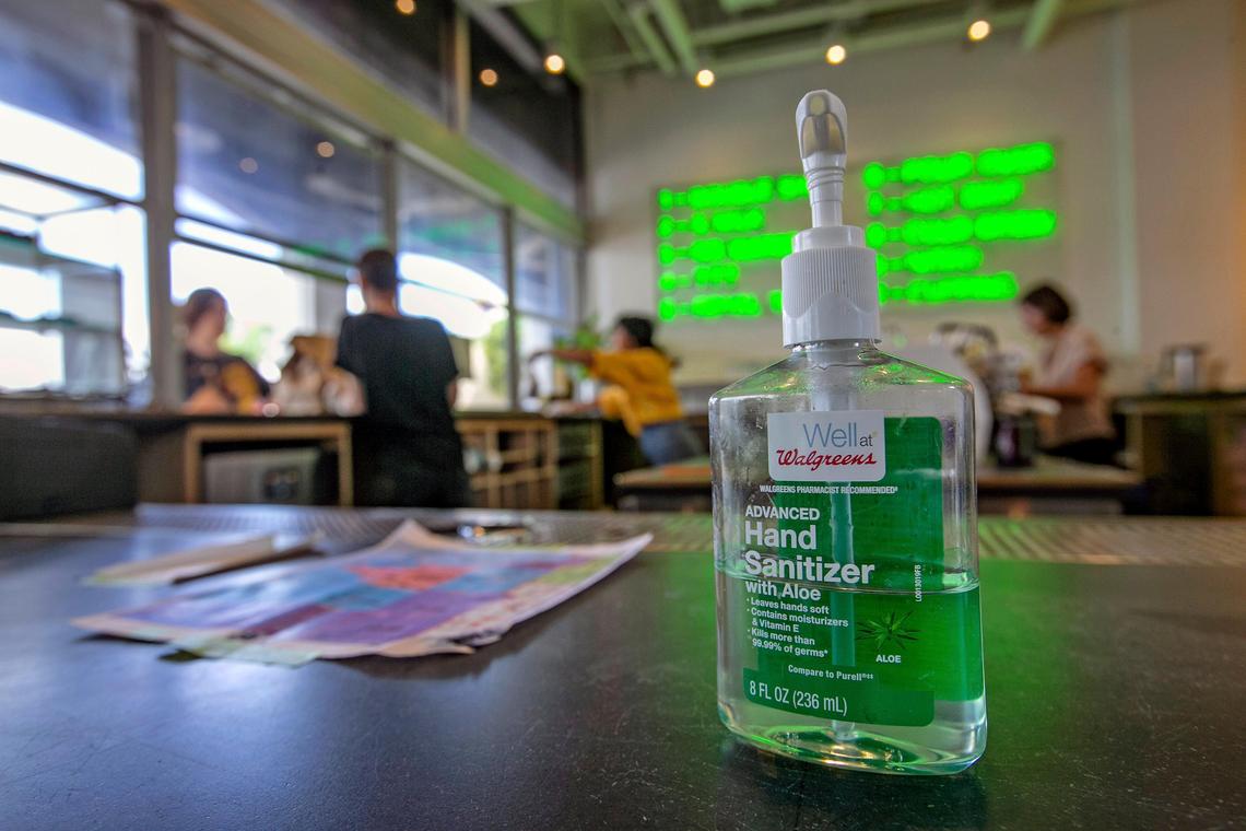 At All Day, a coffee shop and restaurant in downtown Miami a bottle of hand sanitizer is seen on the counter on Wednesday, March 25, 2020. Due to COVID-19 many restaurants have adjusted their hours and offer expanded services for pick up or delivery and several are turning to selling groceries that would be otherwise stuck up the supply chain at farms, dairies and ranches.