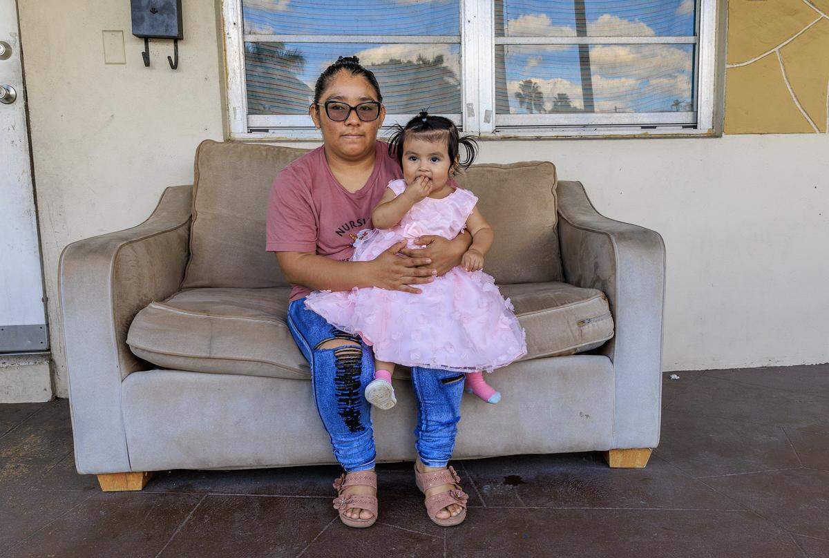 Farmer worker Leyla Ac Choc, of Guatemala posed with her daughter Melany Reynoso, 14.m.o, as she talks about her financial hardship and change in living situation after her husband was deported, leaving her as the sole family provider. In Homestead on Saturday, November 15, 2025.