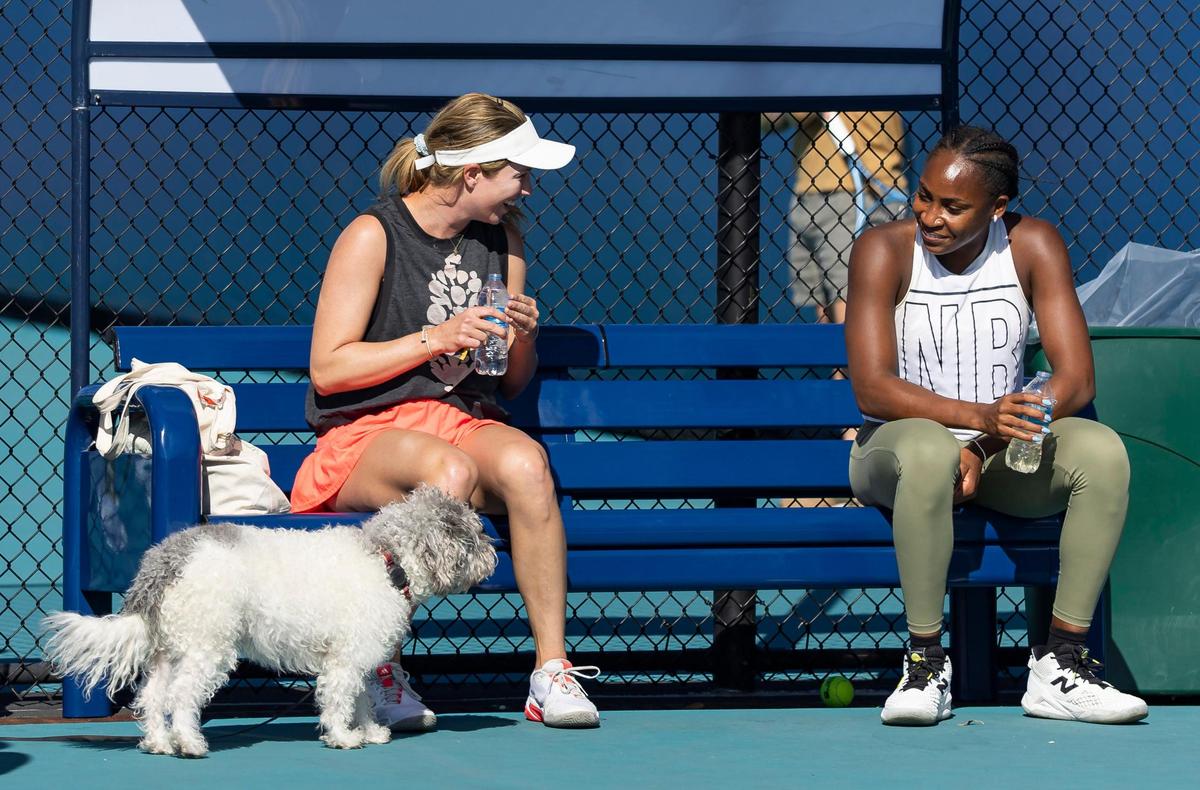 Danielle Collins, left, alongside her dog, Quincy, talks with Coco Gauff during a practice session at the Miami Open tennis tournament on Tuesday, March 18, 2025, at Hard Rock Stadium in Miami Gardens, Fla.