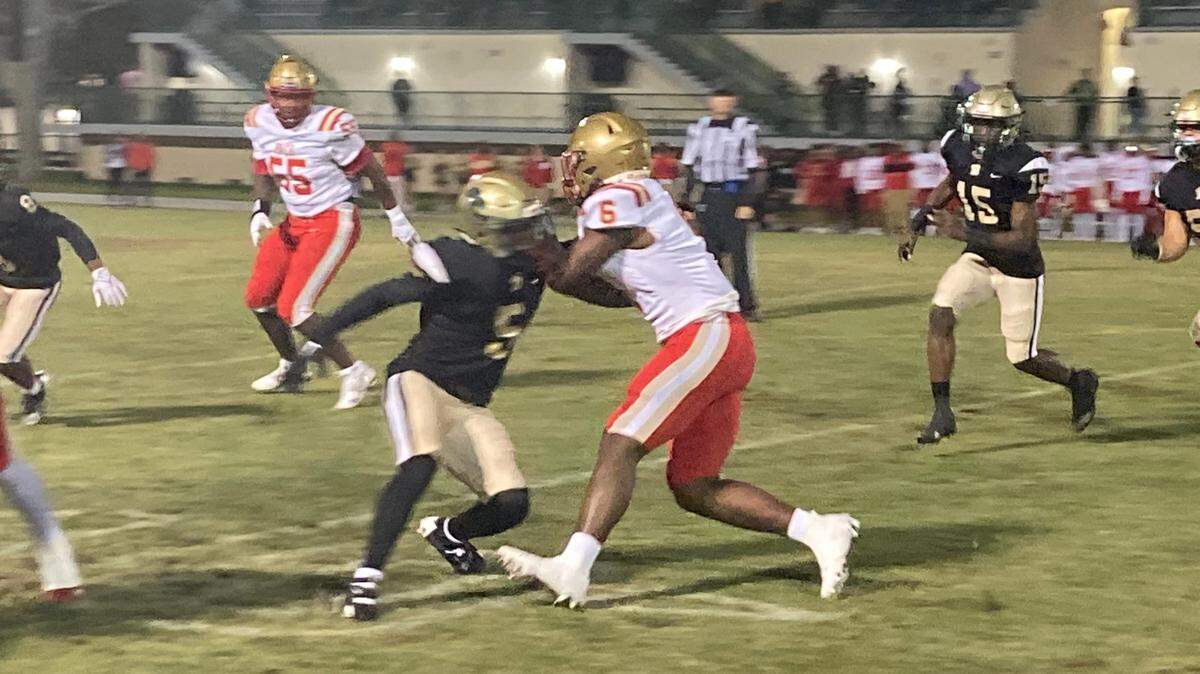 La Salle defender Wendell Copeland (5) brings down Monsignor Pace quarterback Sean Ponder during a Region 4-2A semifinal football game Friday night at La Salle.