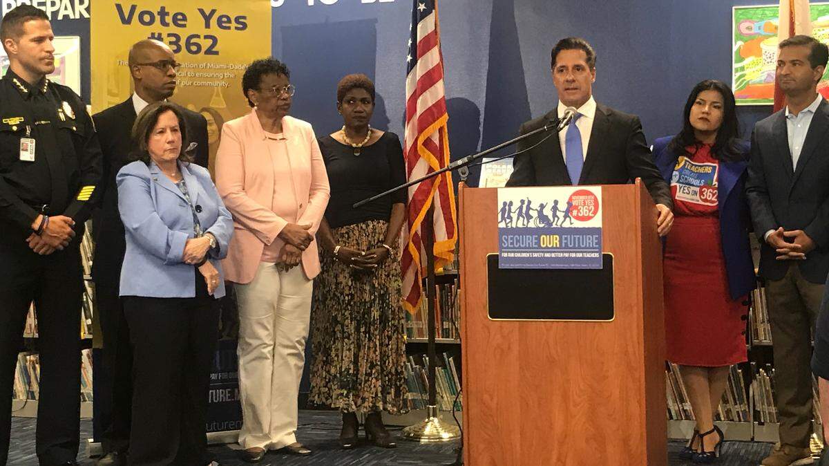 Aventura Mayor Enid Weisman, to the left in a blue jacket, stands in support as Miami-Dade Schools Superintendent Alberto Carvalho, center, speaks at an October 2018 press conference at Madie Ives K-8 in North Miami Beach for a property tax referendum benefiting teachers and schools police. Weisman and Carvalho are longtime friends and colleagues. Weisman previously worked as the school district’s human resources chief under Carvalho.